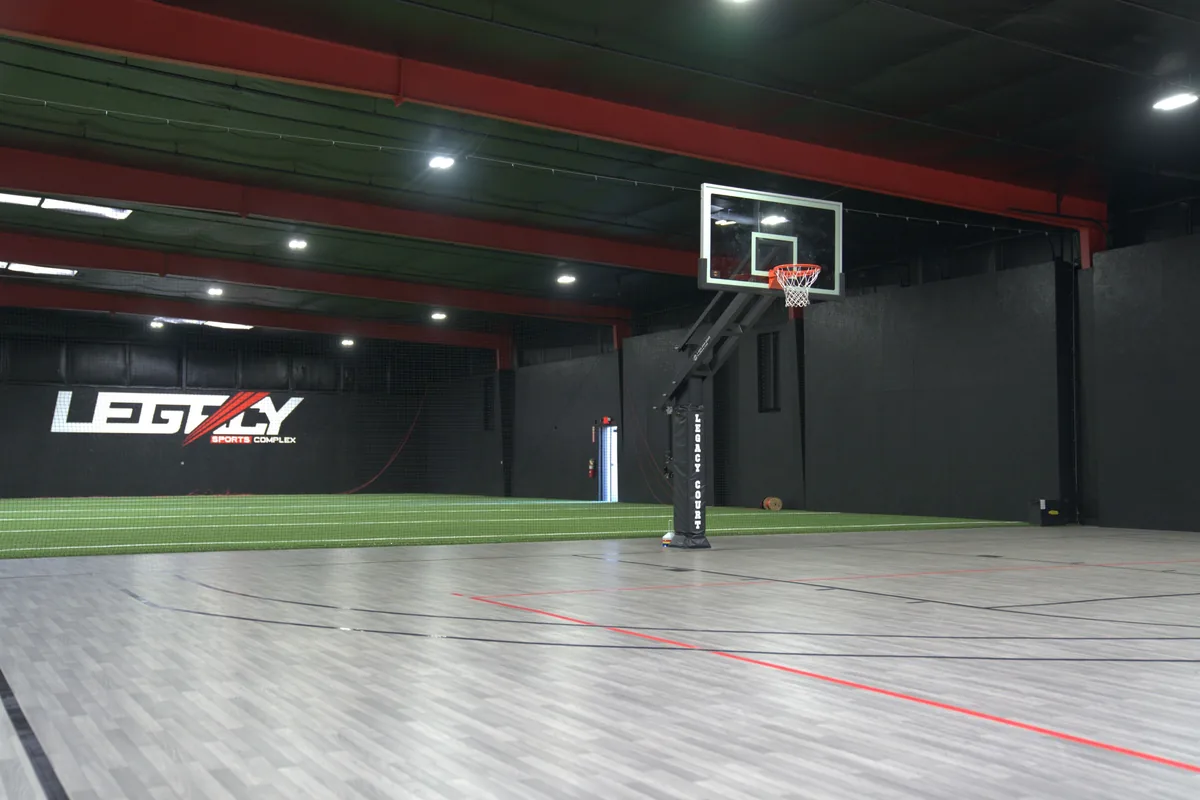 The hardwood basketball court seen from the corner of the building.